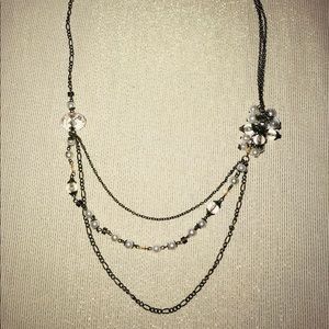 Layered necklace with pearl accents.